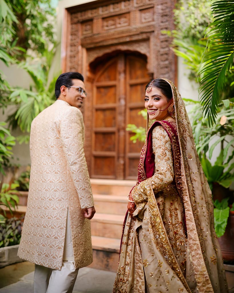 Best Photo Studio In Karachi capturing bride and groom at a heritage doorway portrait